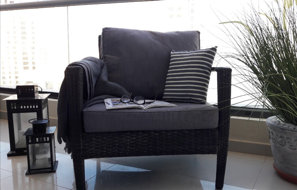 Styled balcony armchair with city view