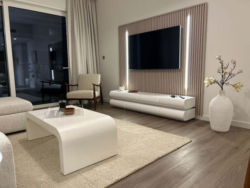 Styled living room with wood-slat media wall
