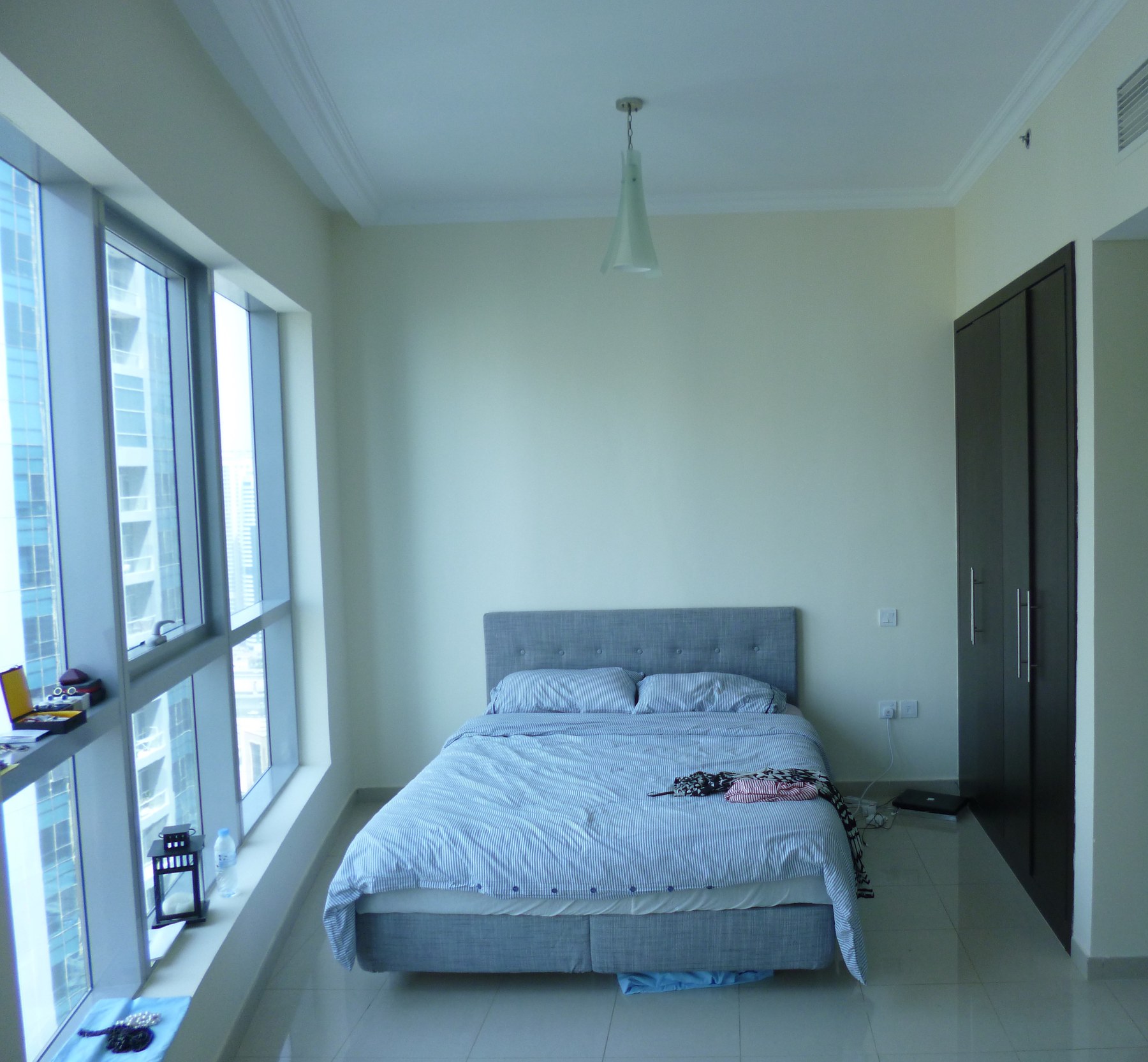 Before — unstyled bedroom with city view