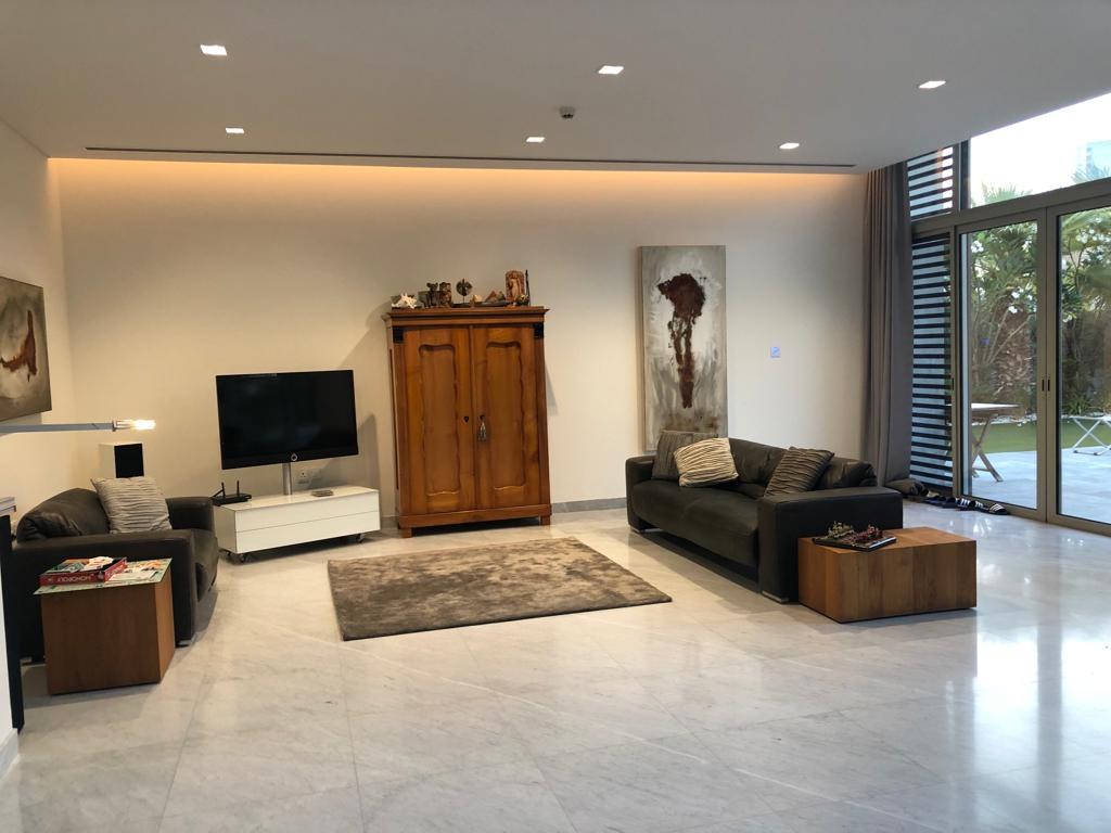 Before — living room with dark leather seating