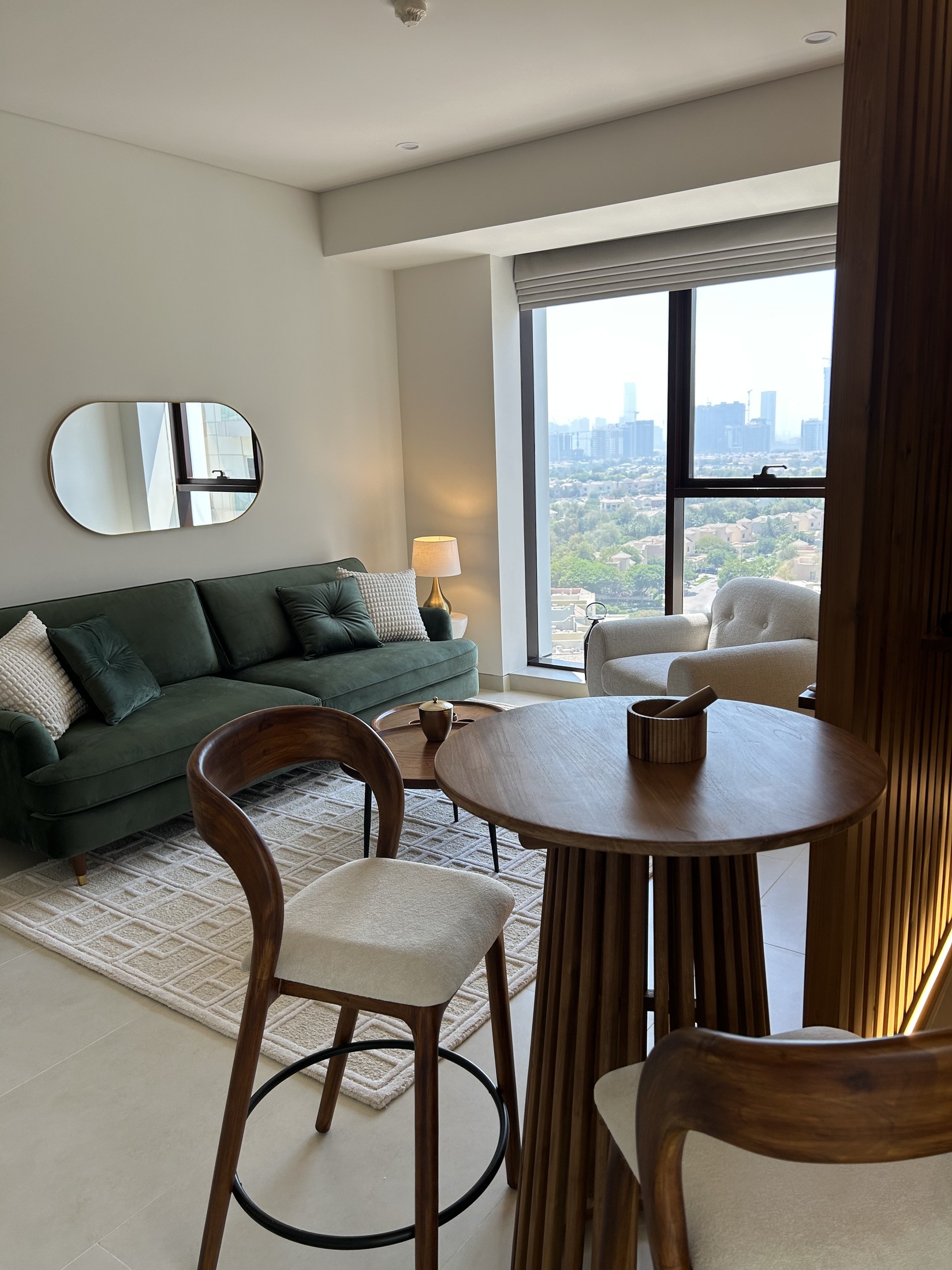 Living and dining with green velvet sofa